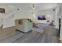 Bright living room featuring hardwood floors, a fireplace, and a ceiling fan at 133 Pasadena Rd, Garner, NC 27529