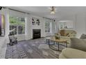 Inviting living room with fireplace, carpet, and large windows that let in lots of natural light at 133 Pasadena Rd, Garner, NC 27529