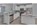 Modern kitchen boasts white cabinets, granite countertops, and stainless steel appliances perfect for cooking at 138 Yellow Jacket Rdg, Clayton, NC 27520