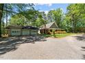 Spacious home with detached garage on a large lot, surrounded by mature trees at 1414 Walter Bright Rd, Sanford, NC 27330