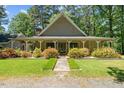 Charming single-story home featuring a welcoming front porch and well-maintained landscaping at 1414 Walter Bright Rd, Sanford, NC 27330