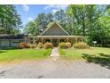 Charming single-story home featuring a welcoming front porch and well-maintained landscaping at 1414 Walter Bright Rd, Sanford, NC 27330