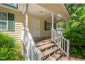 Inviting front porch with white railings and stairs leading to the entrance at 145 Mark St, Franklinton, NC 27525