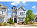 Charming two-story home featuring a welcoming front porch and beautifully landscaped yard at 1601 Glazebrook Dr, Wake Forest, NC 27587