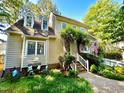 Inviting two-story house with charming landscaping, white picket fence, and classic architectural details at 1712 Briarforest Pl, Raleigh, NC 27615