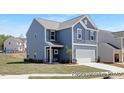 Beautiful two-story home with blue siding, white trim, and a well-manicured lawn at 187 Curling Creek Dr # 298P, Clayton, NC 27527