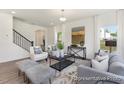 Open-concept living room featuring sleek furniture, stylish decor, and plenty of natural light at 187 Curling Creek Dr # 298P, Clayton, NC 27527