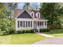 Charming home with manicured front lawn and inviting front porch in a serene, wooded setting at 200 Weybossett Rd, Henderson, NC 27537