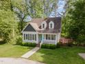 Charming home with manicured front lawn and inviting front porch in a serene, wooded setting at 200 Weybossett Rd, Henderson, NC 27537