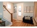 Charming entryway with hardwood floors, a staircase, and stylish decor at 201 Annabelle Blue Drive, Wake Forest, NC 27587