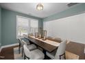 Elegant dining room with a modern table setting, large windows, and soft, neutral wall colors at 212 Crisp Rd, Durham, NC 27713
