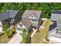 An aerial view of a well-maintained house featuring a fenced backyard and beautiful landscaping at 214 Dogwood Blossoms Dr, Durham, NC 27703
