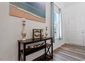 Stylish entryway featuring a decorative table, beach painting and a view to the entry door at 214 Dogwood Blossoms Dr, Durham, NC 27703