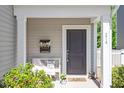 Inviting front porch with seating, decorative plants and flowers and a welcoming front door at 214 Dogwood Blossoms Dr, Durham, NC 27703