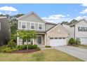 Charming two-story home with brick accents, manicured lawn, and a welcoming front porch with seating at 2650 Turner Pines Dr, New Hill, NC 27562