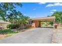 A well-maintained brick home with a convenient carport, showcasing an inviting exterior and manicured landscaping at 2917 Trail Six, Burlington, NC 27215