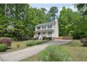 Beautiful two-story home featuring a front porch and a long, paved driveway at 300 Hutchins Dr, Garner, NC 27529