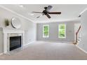 Inviting living room with a fireplace, ceiling fan, neutral paint, and large windows at 300 Silvercliff Trl, Cary, NC 27513