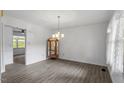 Spacious living room with hardwood floors, a decorative chandelier, and ample natural light at 300 Wakewood Ct, Raleigh, NC 27615