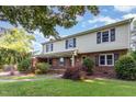 Lovely home with a brick and vinyl exterior, complemented by a lush front yard and mature landscaping at 3209 Marie Dr, Raleigh, NC 27604