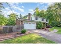 View of the home's two-car garage, siding, brick exterior, landscaping, and long driveway at 3209 Marie Dr, Raleigh, NC 27604