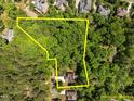 Expansive wooded lot with mature trees, offering privacy and seclusion, perfect for building a custom home at 3425 Donnigale Ave, Durham, NC 27705