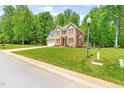 Spacious home with a lush lawn, mature trees, and a charming deck at 3436 Candlebrook Ct, Mebane, NC 27302