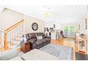 Bright living room featuring hardwood floors, a ceiling fan, and an open layout at 3436 Candlebrook Ct, Mebane, NC 27302