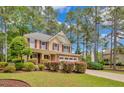 Charming two-story home with manicured landscaping, a stone facade, and a two-car garage at 35 Pine Water Way, Spring Lake, NC 28390