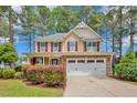 Charming home with a stone and siding exterior, red shutters, and a two-car garage at 35 Pine Water Way, Spring Lake, NC 28390