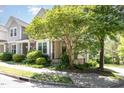 Inviting front of home features mature tree offering shade and curb appeal at 4002 Cherry Blossom Cir, Durham, NC 27713