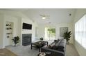 Bright living room with fireplace, neutral carpet, slider to balcony, and gray sofa at 4024 Claret Ln, Morrisville, NC 27560
