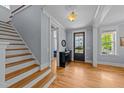 Bright foyer with hardwood floors and staircase leading to the upper level at 508 Vervain Way, Holly Springs, NC 27540