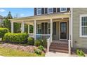 Inviting front porch with comfortable seating, perfect for relaxing outdoors at 508 Vervain Way, Holly Springs, NC 27540