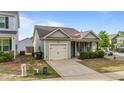 Charming single-story home with a well-manicured lawn and inviting covered front porch at 51 Balboa Parkway Pkwy, Clayton, NC 27520