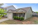 Charming single-story home with a well-manicured lawn and inviting covered front porch at 51 Balboa Parkway Pkwy, Clayton, NC 27520