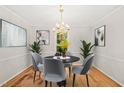 Elegant dining room with a chandelier, modern art, and a round dining table at 5212 Badham Pl, Raleigh, NC 27609