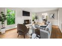 Cozy living room featuring a fireplace, lots of natural light, and modern furnishings at 5212 Badham Pl, Raleigh, NC 27609