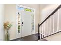 Inviting entryway with a bright white door, sidelights, and dark wood floors at 5504 Crabtree Park Ct, Raleigh, NC 27612