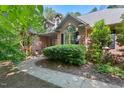 Attractive brick home displaying lush greenery, dormer windows, and a well-maintained landscape at 5524 Jomali Dr, Durham, NC 27705