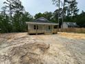 Quaint home with inviting front porch, nestled amongst trees, with a neighboring house in the distance at 604 Natchez Trace, Fuquay Varina, NC 27526