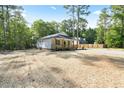 Beautifully landscaped single-story home with a charming covered porch, surrounded by lush greenery at 604 Natchez Trace, Fuquay Varina, NC 27526