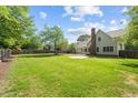 Expansive green backyard with mature trees, offering ample space and privacy at 608 Driftwood Dr, Gibsonville, NC 27249