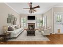 Bright living room with fireplace, hardwood floors, neutral colors, and lots of light at 608 Driftwood Dr, Gibsonville, NC 27249