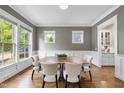 Elegant dining room with stylish chairs, hardwood floors, and lots of natural light at 707 Sasser St, Raleigh, NC 27604