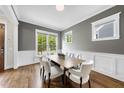 Bright dining room features hardwood floors, white trim, and a large window at 707 Sasser St, Raleigh, NC 27604