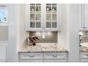 Stylish wet bar featuring granite counters, white cabinets, and a wine rack at 707 Sasser St, Raleigh, NC 27604
