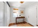 Bright entryway with hardwood floors, stylish console table, decorative lighting, and white trim throughout the house at 713 E Whitaker Mill Rd, Raleigh, NC 27608
