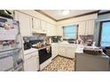 Functional kitchen with white cabinets, contrasting countertops, and essential appliances for a comfortable cooking experience at 7312 Ray Rd, Raleigh, NC 27613