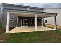View of the back porch with white columns and sliding door entry at 776 Old Station Pointe, Angier, NC 27501